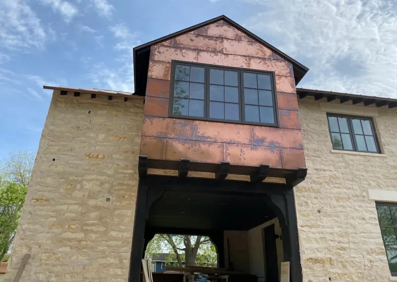 Copper metal panel facade on a stone building for Metal Roof Coating in Chattanooga